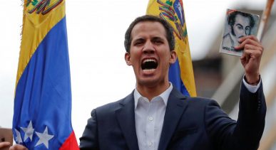 Juan Guaido, President of Venezuela's National Assembly, holds a copy of Venezuelan constitution during a rally against Venezuelan President Nicolas Maduro's government and to commemorate the 61st anniversary of the end of the dictatorship of Marcos Perez Jimenez in Caracas, Venezuela January 23, 2019. REUTERS/Carlos Garcia Rawlins